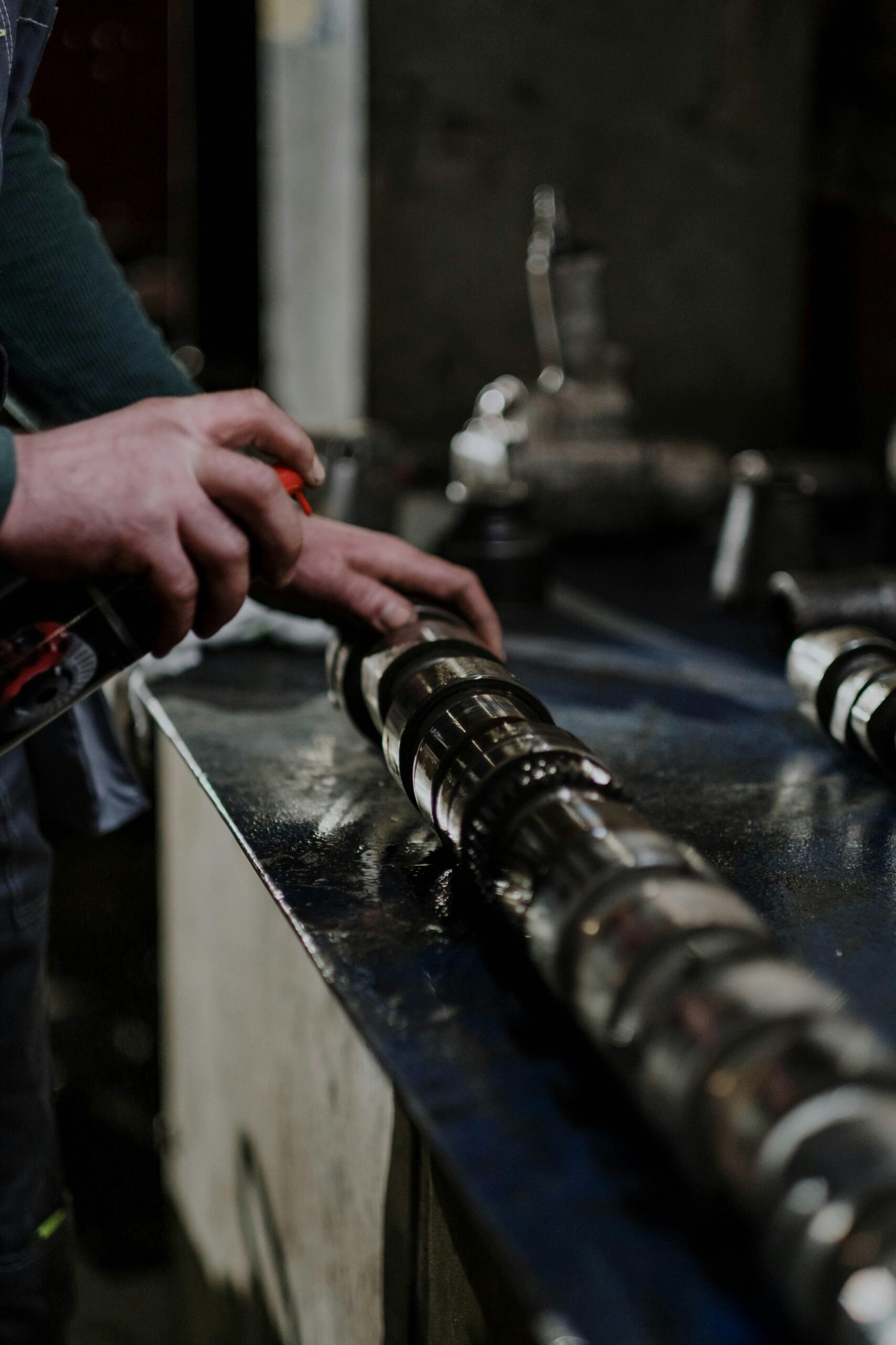Automotive Core Tools - A person greasing parts of an engine