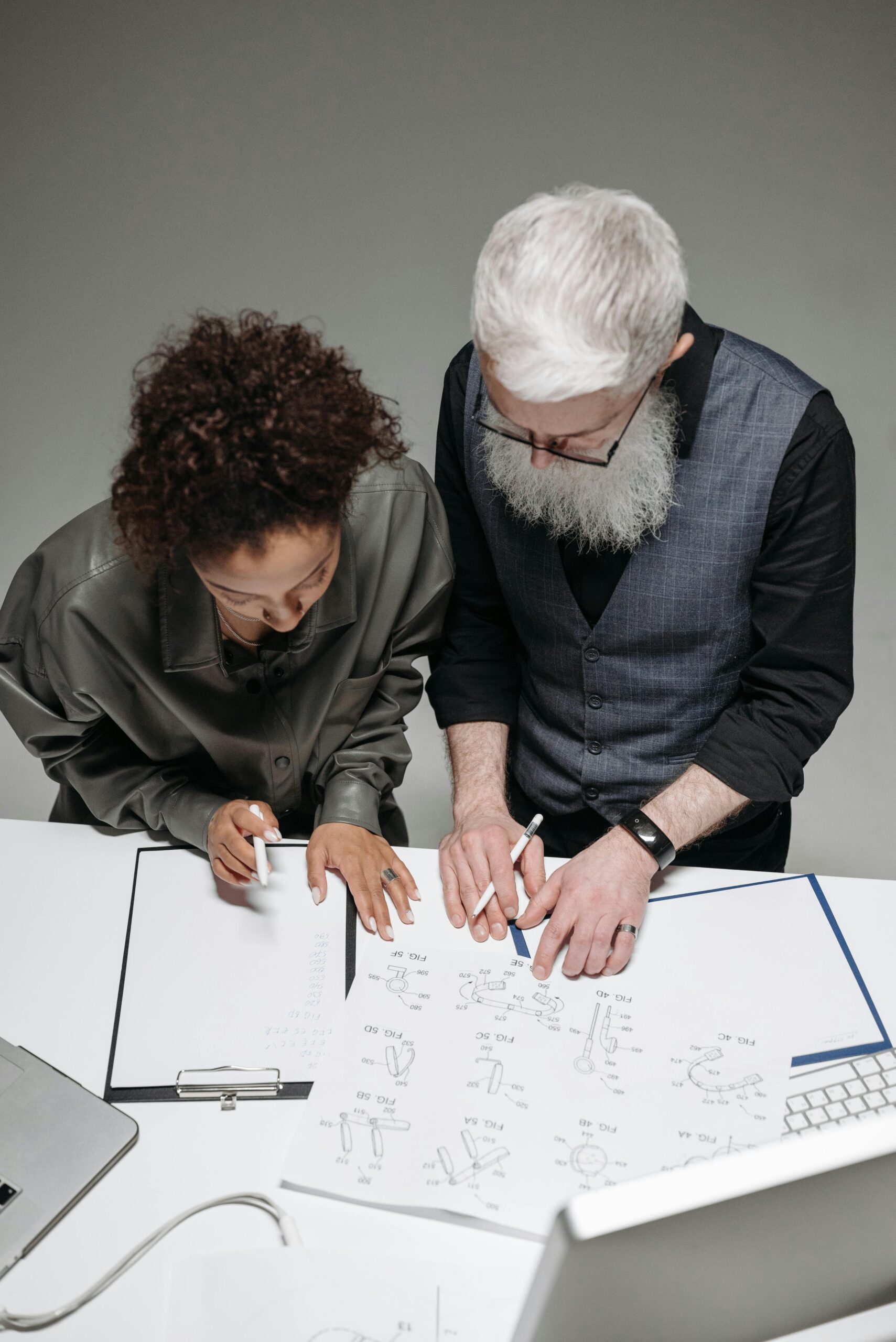 Design and Development: Two people looking down at a design on a table