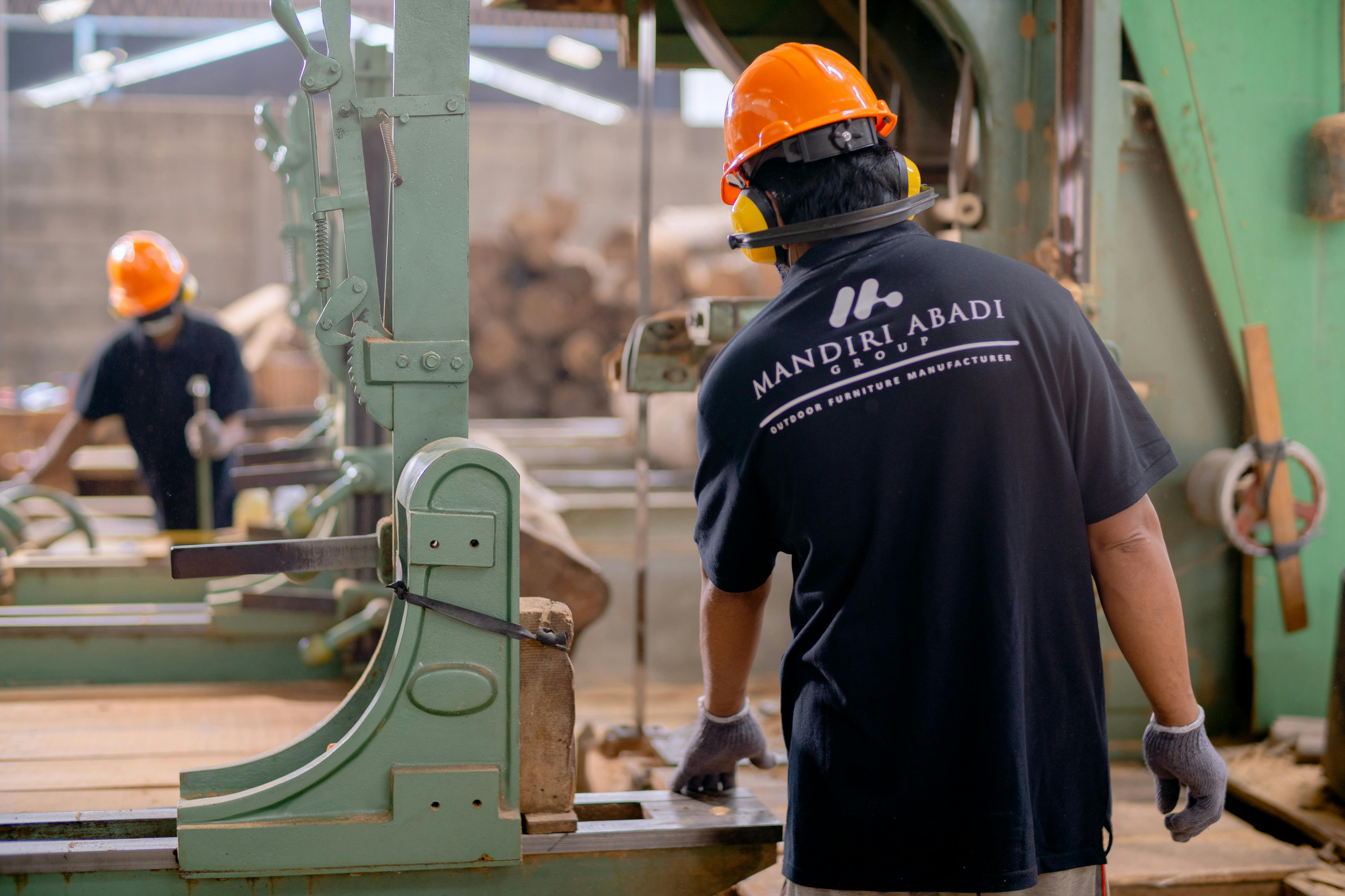 ISO 9001:2026 revision: 2 people in PPE working on manufacturing machines