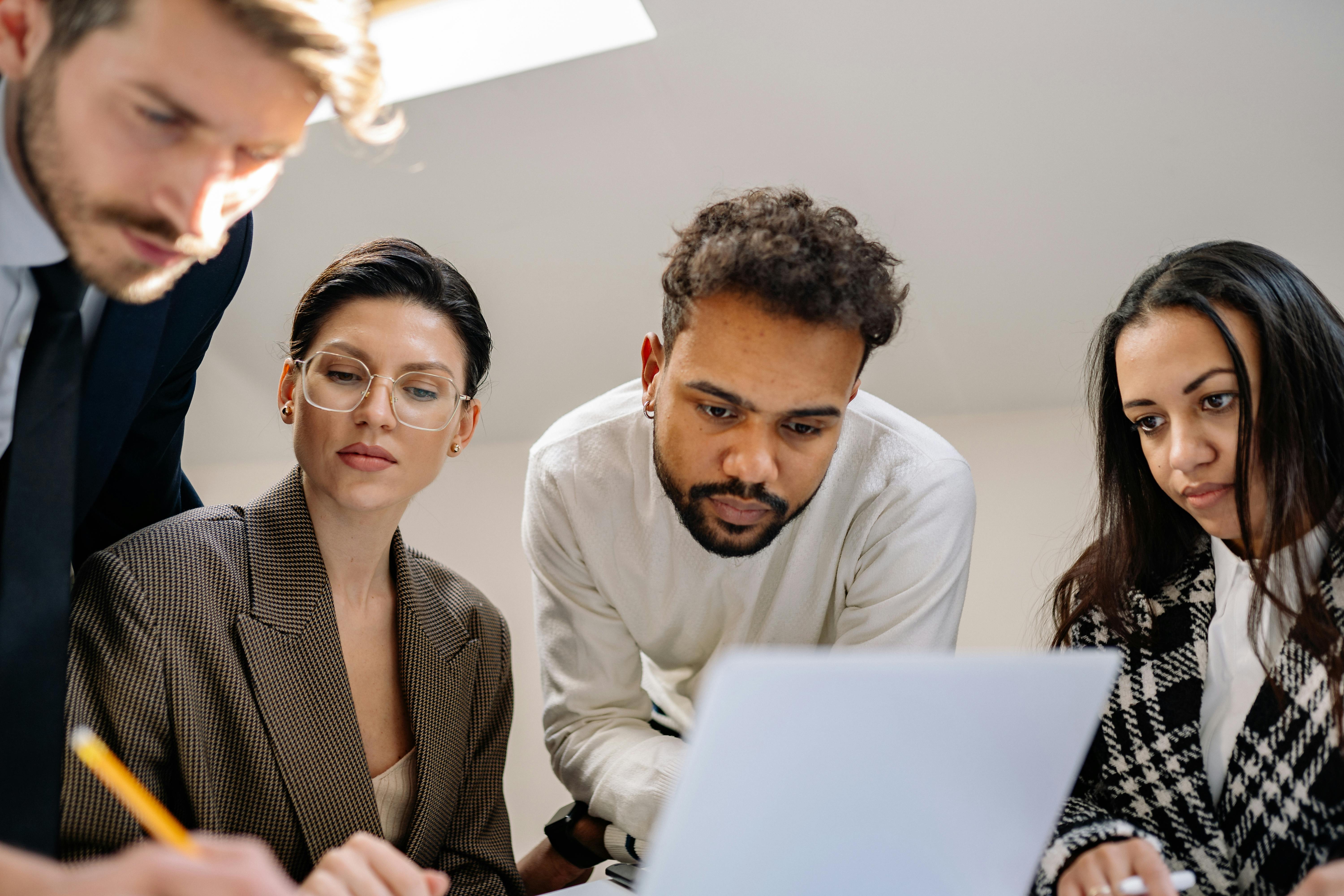 Root Cause Analysis Training - Four people looking at a document